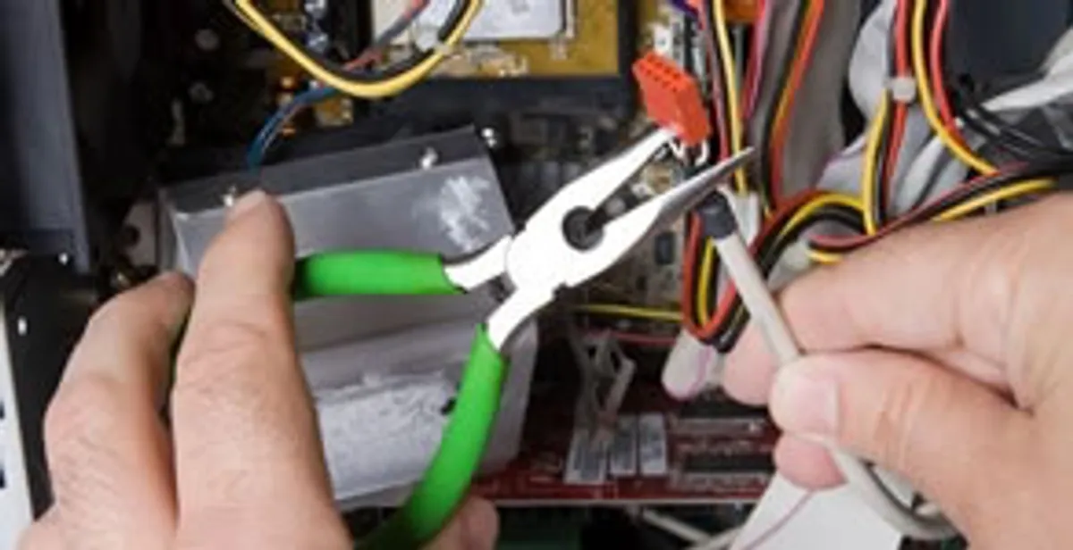 Licensed electrical contractor performing electrical repair with tools in Oneida, WI
