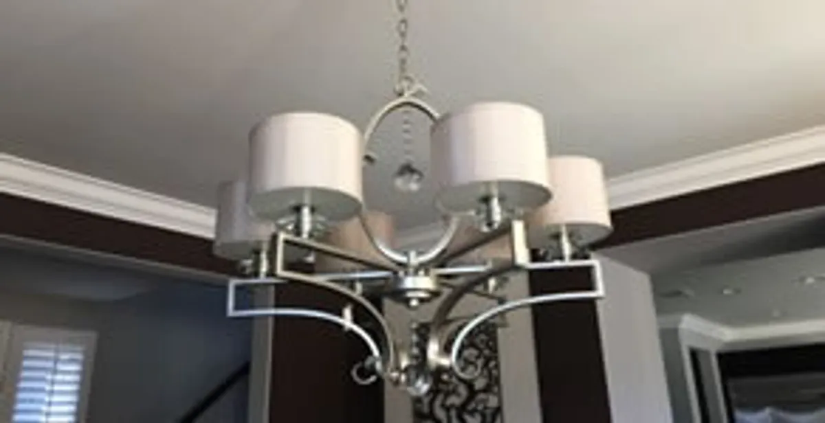 Modern chandelier installation with multiple light fixtures in Green Bay, WI